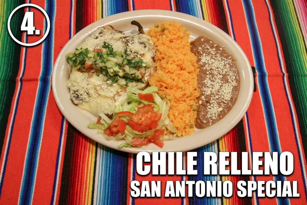 A plate of food on a table with the words chile relleno san antonio springs.