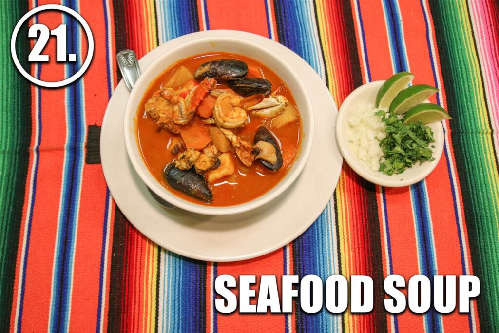 A bowl of seafood soup on the table.